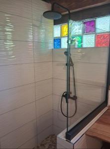 a shower with stained glass windows in a bathroom at Tema'e Beach House in Temae +45 photos