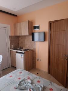 a small kitchen with a bed in a room at Grandino rooms & apartments in Ulcinj