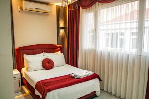 a bedroom with a bed with a red headboard and a window at Viva Rooms in Istanbul