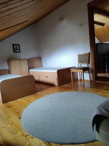 a bedroom with a bed and a chair and a rug at SunKiss in Melnragė