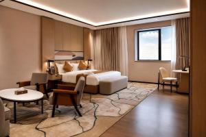 a hotel room with a bed and a table and chairs at Twin Burj Hotel in Nouakchott +55 photos