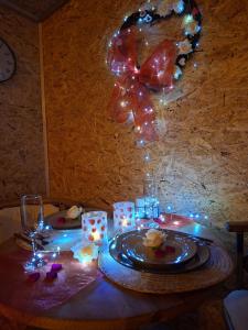 a table with a plate of food and lights on it at Chatka U Vlka in Lnáře