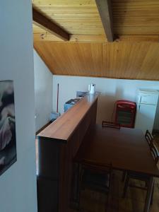 a dining room with a wooden counter and a table at SunKiss in Melnragė