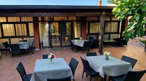 two tables and chairs in a restaurant with tables and chairs at B&B Sant'Antonio in Gallipoli