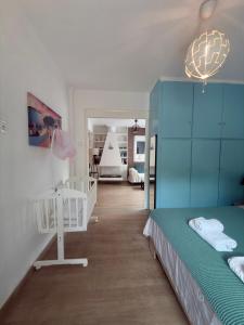 a bedroom with a bed and a blue wall at Luxury suites XiangBaLa Glyfada in Athens