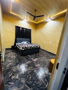 a bedroom with a bed and lights on the floor at Countryside forest village in Udhampur