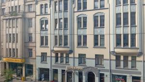 a tall building with many windows on a city street at City Centre Cozy Guesthouse in Riga