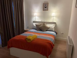 a bedroom with a bed with two towels on it at La Vio Homestay Private Room & Bathroom, Newcastle Dublin in Newcastle