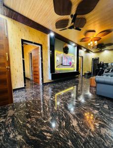 a living room with a tv and a ceiling at Countryside forest village in Udhampur