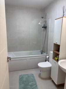 a bathroom with a tub and a toilet and a sink at La Vio Homestay Private Room & Bathroom, Newcastle Dublin in Newcastle +5 photos