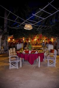 a table with chairs and a table with food on it at Tente et Restaurant ElBey in Douz