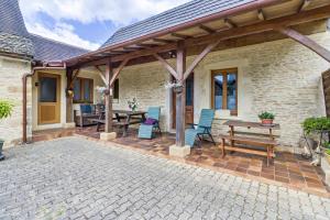 a patio with a wooden pergola and a table and chairs at Gite Périgourdin - 2 Chambres in Saint-Geniès