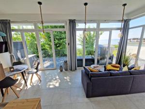 a living room with a couch and a table at Villa Küstenperle, Meerblick-Appartements in Sassnitz