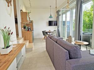 a living room with a couch and a table at Villa Küstenperle, Meerblick-Appartements in Sassnitz +9 photos