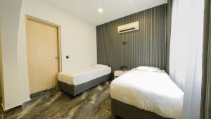 a small bedroom with a bed and a mirror at LEGEND TULIP HOTEL in Antalya