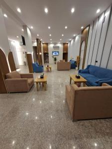 a lobby with couches and tables in a building at راحتي ستار للشقق المخدومة in Ukaz