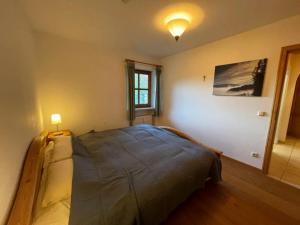 a bedroom with a bed with a light on it at Ferienwohnung Wildbichl in Sachrang in Sachrang