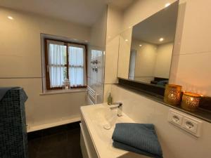 a bathroom with a sink and a mirror at Ferienwohnung Wildbichl in Sachrang in Sachrang +47 photos
