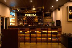 a bar in a restaurant with stools at Nepalirika Hotel Biratchowk in Haraincha