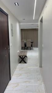 an empty hallway with a bench and a table at Em banorama abrrtment hotel in Giza
