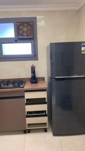 a kitchen with a stove and a refrigerator at Em banorama abrrtment hotel in Giza