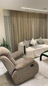 a living room with a couch and a chair at Em banorama abrrtment hotel in Giza +60 photos