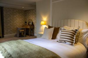 a bedroom with a large bed with striped pillows at The Marlborough Inn in Marlborough +17 photos
