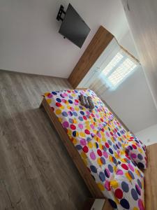a bedroom with a bed with polka dot sheets at Ionela in Năvodari