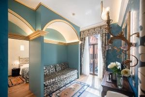 a living room with blue walls and a couch at Hotel Colomba d'Oro in Verona +87 photos