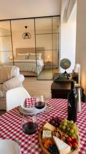 a table with wine glasses and a plate of food at Home2830 in Barreiro +36 photos
