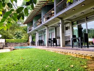 a house with a lawn in front of it at Leisure Land in Galle