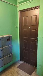 a room with a brown door and a room with some drawers at Rojas street apartments in Liepāja