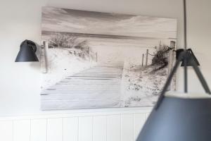 a painting of a boardwalk to the beach at Rothen Huus in Norderney +15 photos