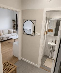 a living room with a sink and a mirror at Mysig lägenhet i centrum in Västerås