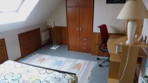 a bedroom with a bed and a desk and a chair at Veigné Room in Veigné