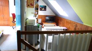 a attic room with a staircase with a tv at Veigné Room in Veigné