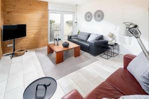a living room with a couch and a table at Seehaus 48 in Norderney