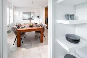 a dining room with a wooden table and chairs at Seehaus 48 in Norderney