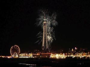 a palm tree and a ferris wheel at night at Las Palmas Hotel by the Sea in Blackpool +47 photos