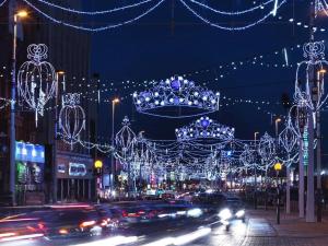 a busy city street with christmas lights and cars at Las Palmas Hotel by the Sea in Blackpool