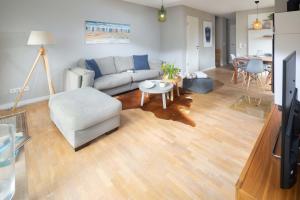 a living room with a couch and a table at Mühlenloft in Norderney