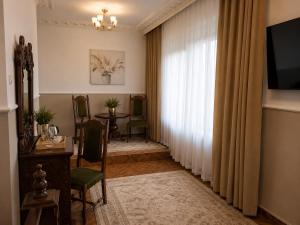 a living room with a window and a table and chairs at Adria in Bieruń Nowy