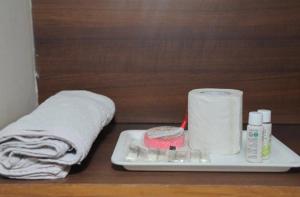 a tray with toilet paper and a roll of towels at Hotel Rama palace in Mathura