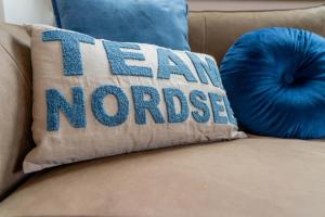 a pillow that says i am noromed sitting on a couch at Neywatt 1 in Norderney