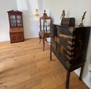a room with an old dresser and a table and chair at Schloss Schmuggerow in Schmuggerow +21 photos
