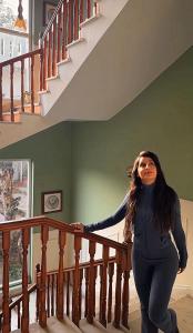 a woman is standing next to a staircase at Casa De Bello, Nainital, Near Kainchi Dham in Bhowāli +68 photos