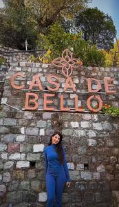 a woman is standing in front of a sign at Casa De Bello, Nainital, Near Kainchi Dham in Bhowāli