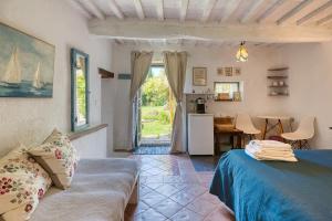 a bedroom with a bed and a table and a door at Assisi Countryhouse in Assisi
