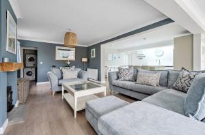 a living room with a couch and a table at Number Twenty Four in West Wittering