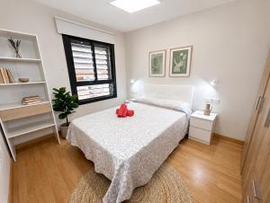 a bedroom with two beds and a red teddy bear on the bed at Brisa del Mar - 2 min playa in El Ejido